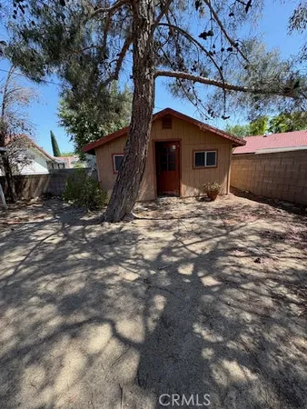 a view of a house with a tree