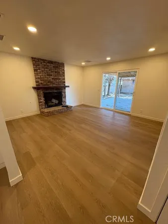 a view of an empty room with a fireplace