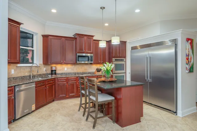 a living room with furniture and a ceiling fan