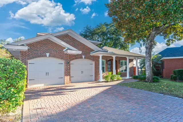 a front view of a house with a garden and yard