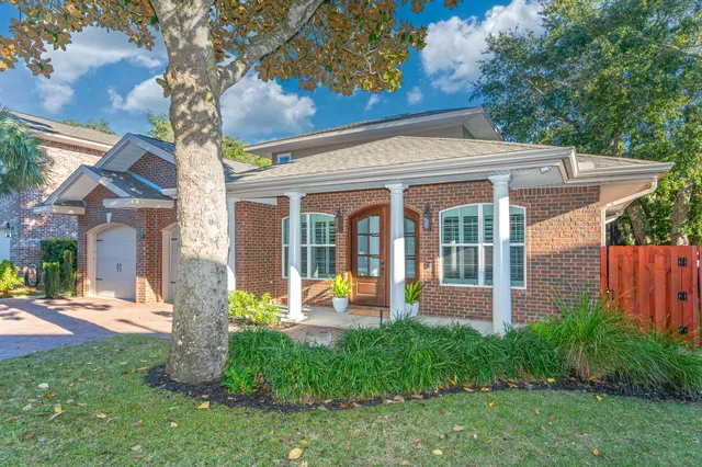 a front view of a house with a garden