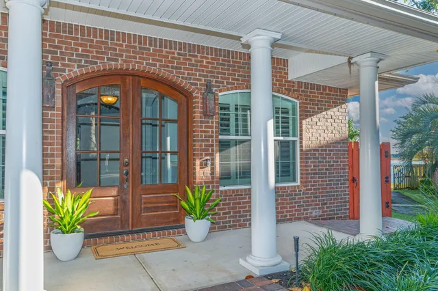 a front view of a house with a potted plant