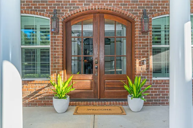 a dining room with furniture a chandelier and window