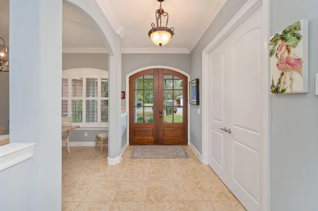 a view of a dining room with furniture a chandelier and wooden floor