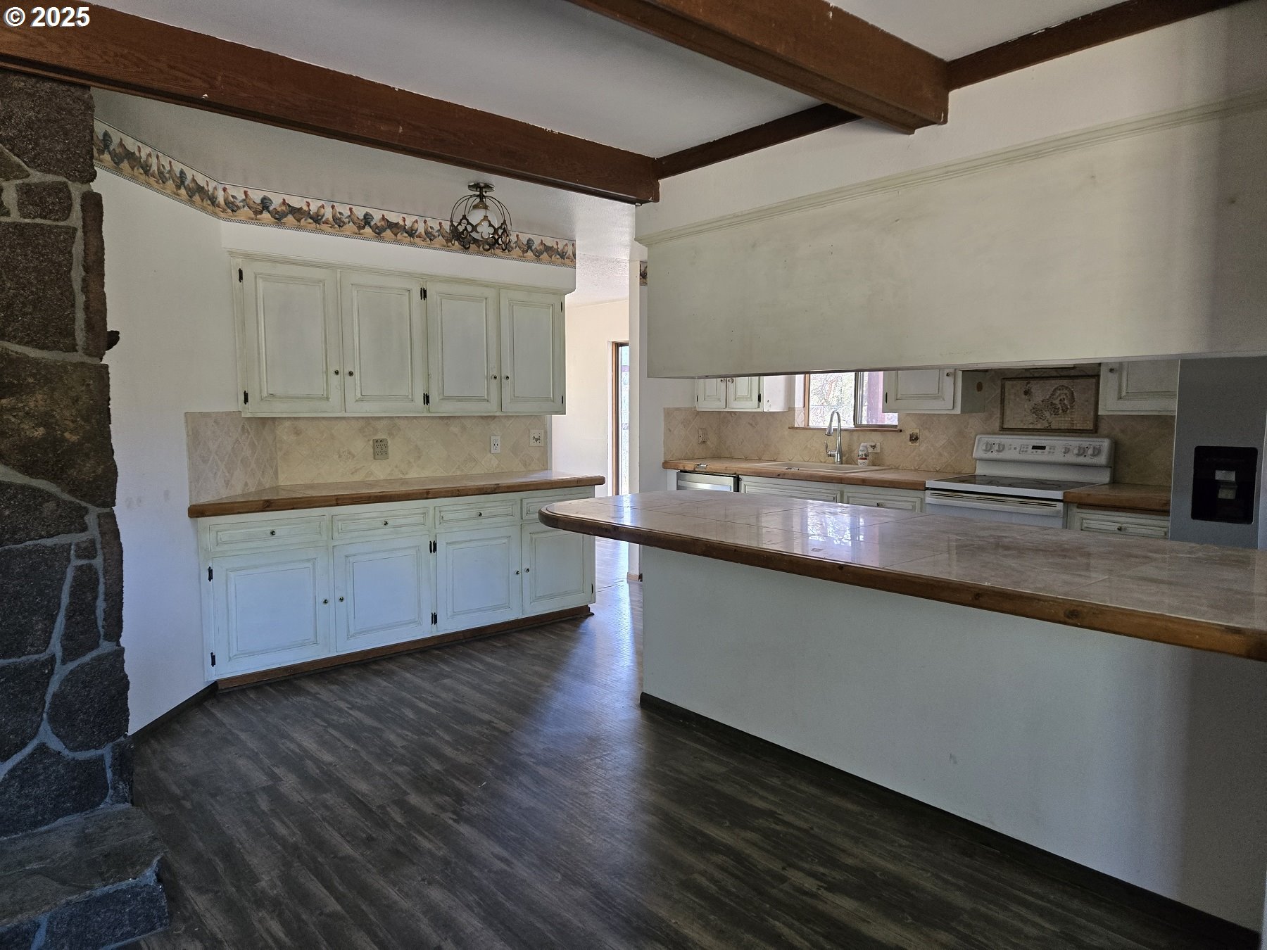 801 Ferguson Road John Day, OR 97845 - Photo 11 of 43 a large kitchen with a lot of counter space and wooden floor
