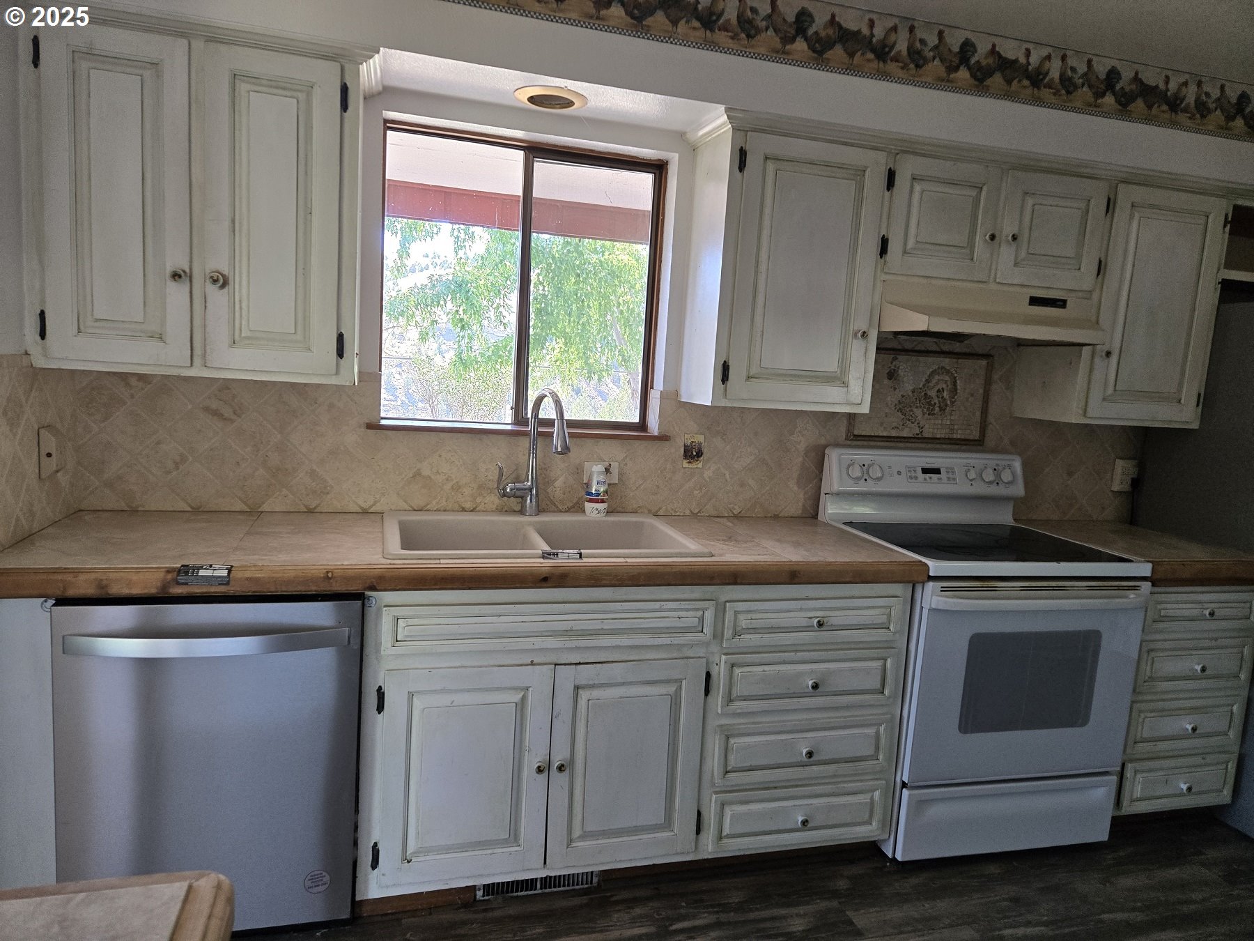 801 Ferguson Road John Day, OR 97845 - Photo 12 of 43 a kitchen with cabinets appliances a sink and a window