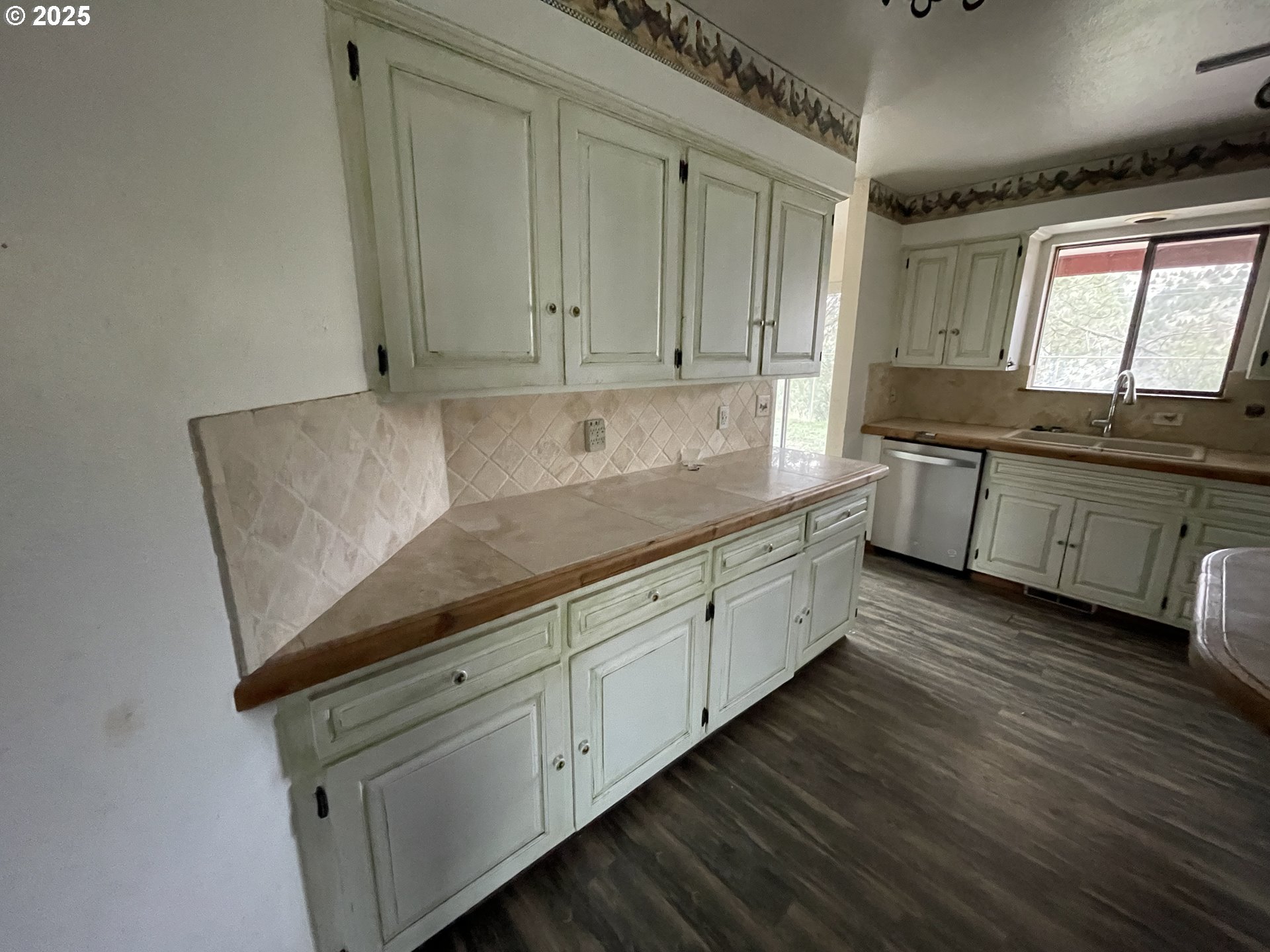 801 Ferguson Road John Day, OR 97845 - Photo 14 of 43 a kitchen with stainless steel appliances granite countertop a sink a stove and a wooden floors