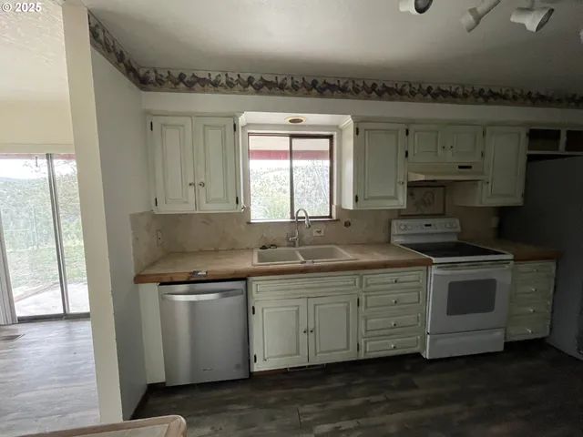 a kitchen with a sink stove and cabinets