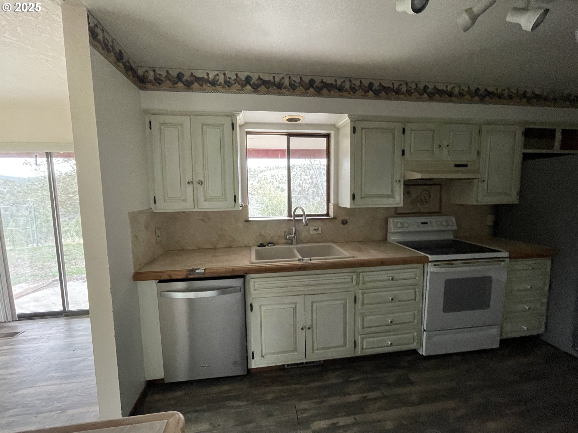 801 Ferguson Road John Day, OR 97845 - Photo 15 of 43 a kitchen with a sink stove and cabinets
