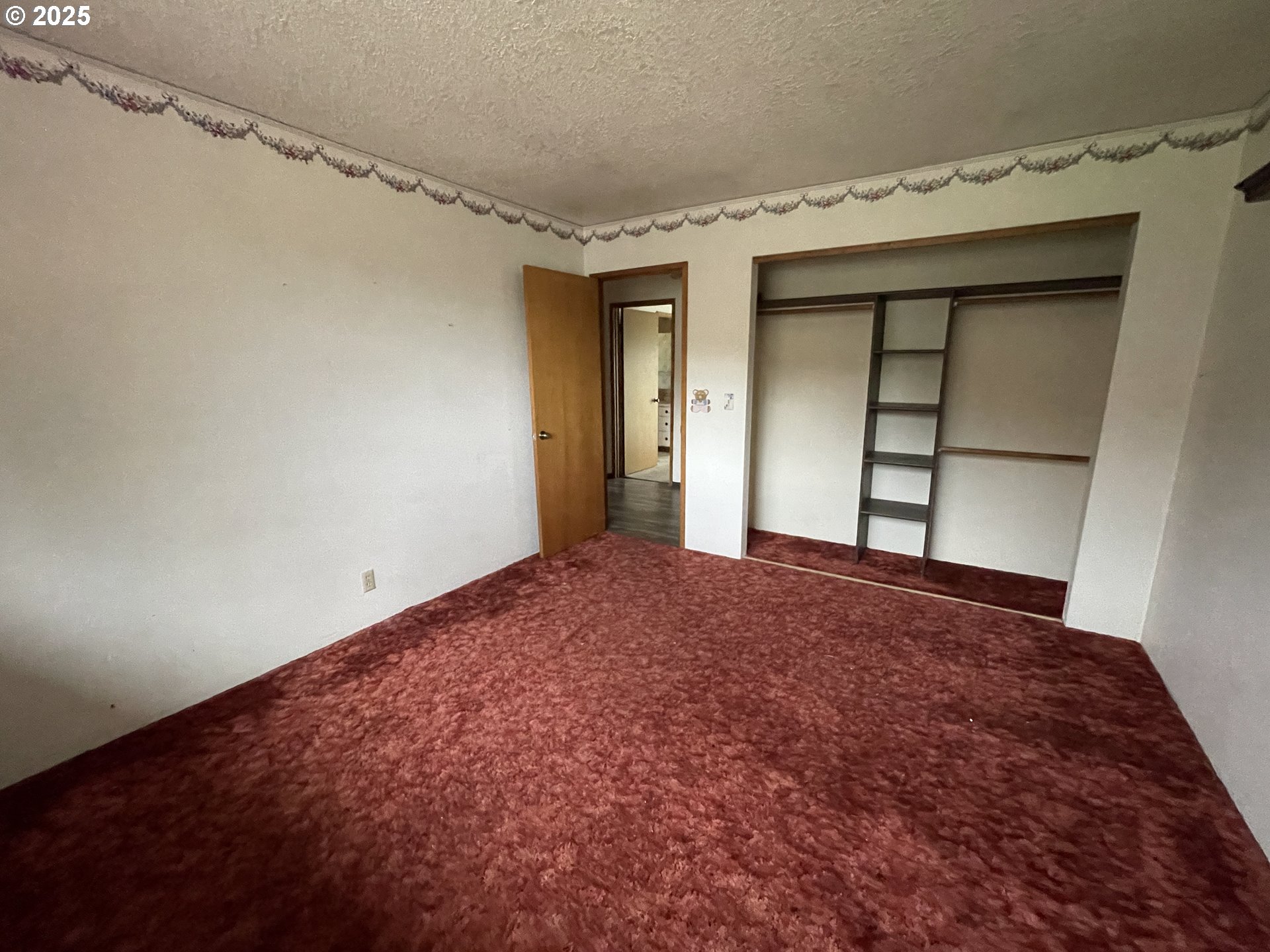 801 Ferguson Road John Day, OR 97845 - Photo 22 of 43 a view of empty room with wooden floor and fan