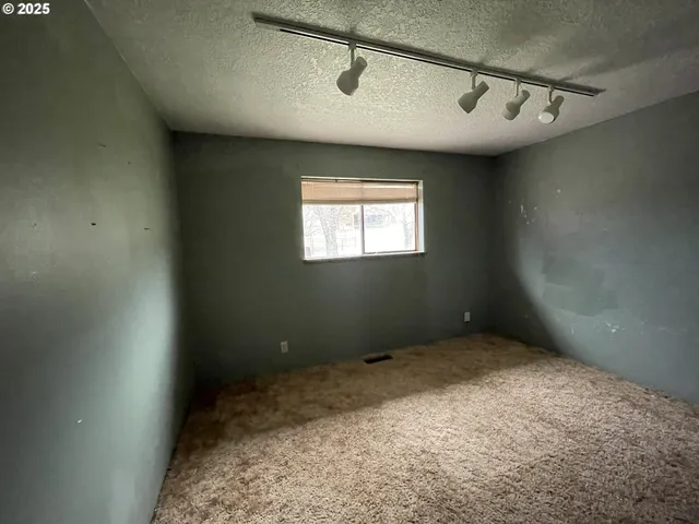 a view of a big room with windows