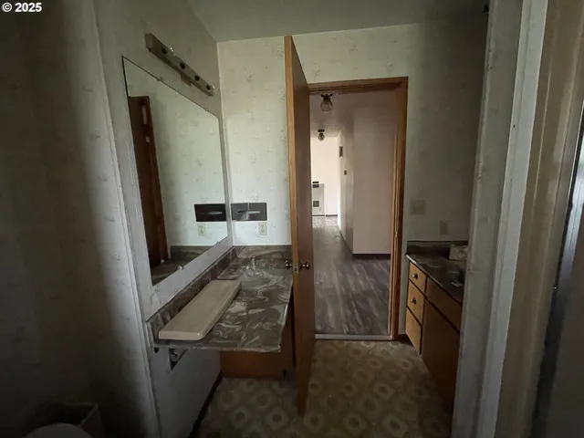 a bathroom with a glass door shower and a sink