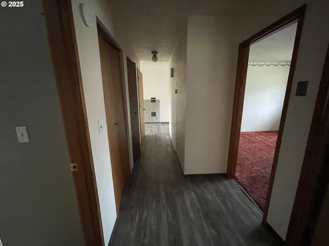 a view of hallway with wooden floor