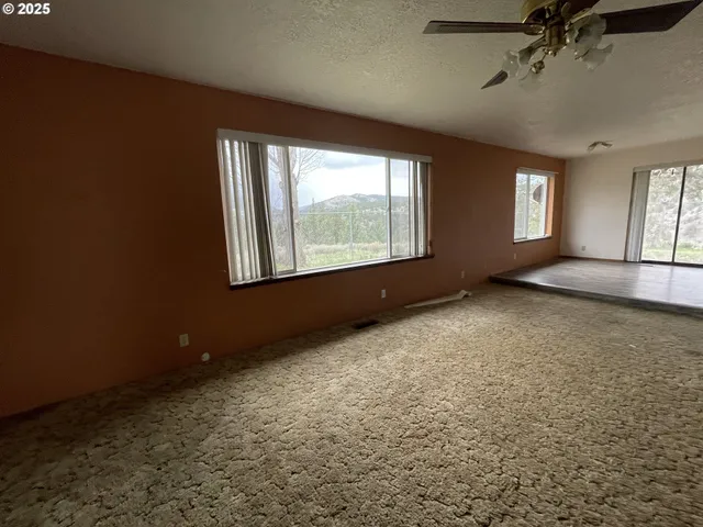 an empty room with a empty space and windows