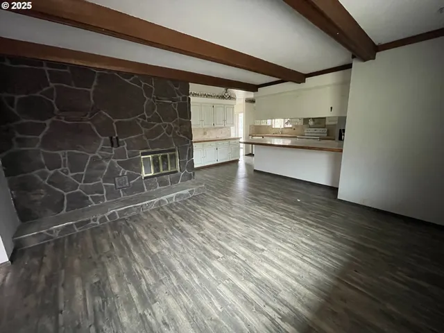 a view of a room with wooden floor and cabinets