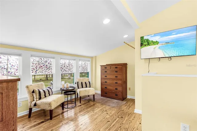 a bedroom with furniture and wooden floor