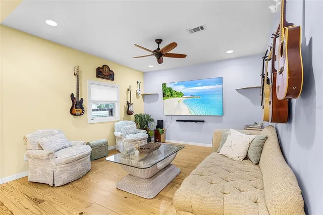 a living room with furniture and a wooden floor