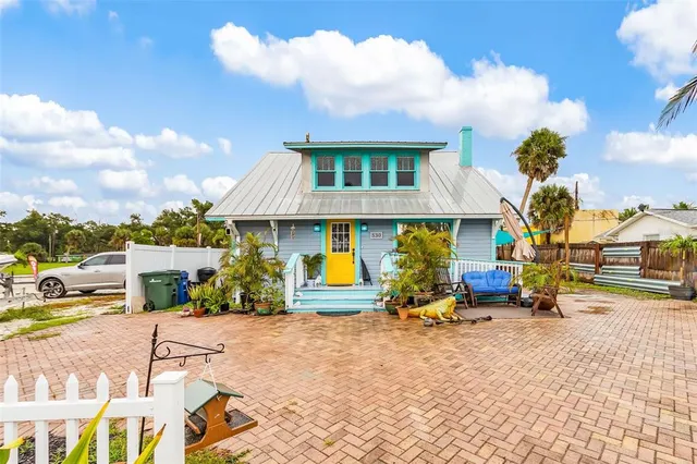 a view of a house with backyard and sitting area