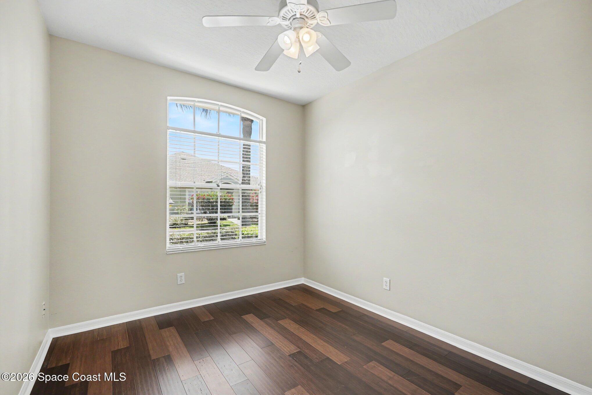 284 Intrepid Way Indialantic, FL 32903 - Photo 24 of 36 an empty room with wooden floor chandelier fan and windows