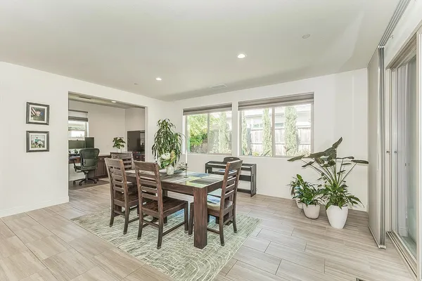 a living room with lots of furniture and kitchen view