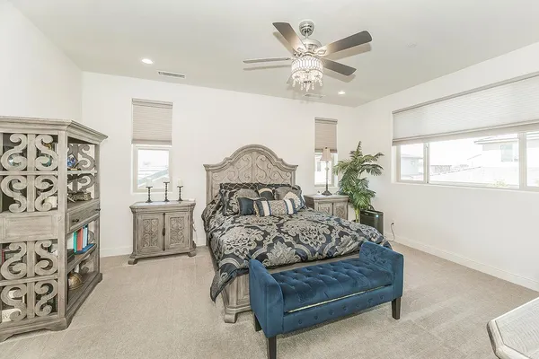 a bedroom with furniture and a chandelier