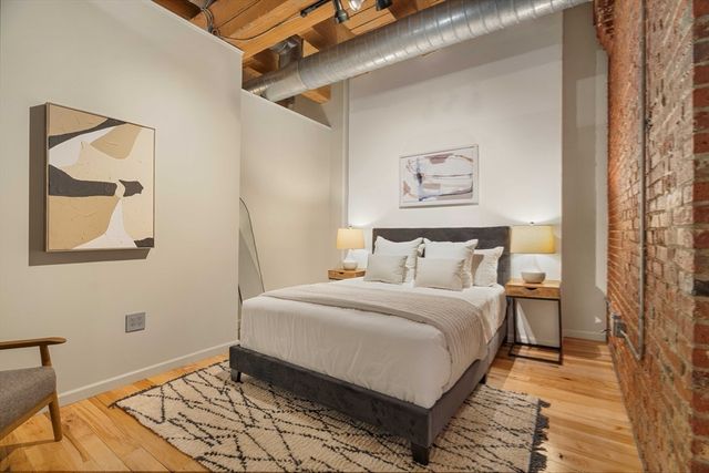 a room with a window and a painting on the wall