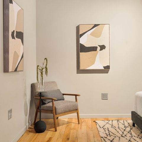 a view of a dining room with furniture a chandelier and wooden floor