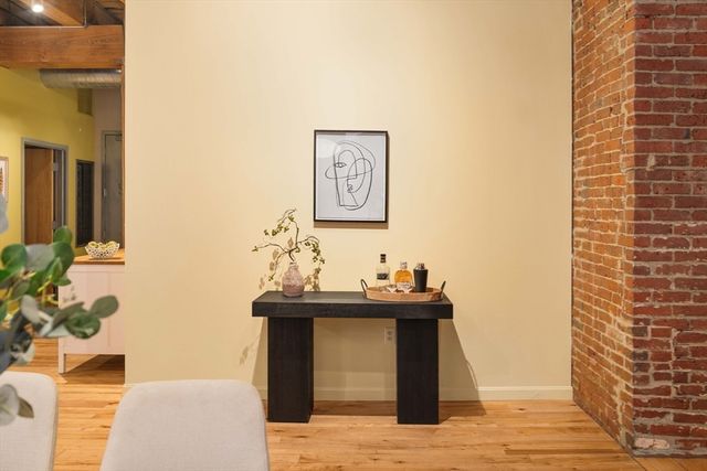 a dining room with furniture and wooden floor