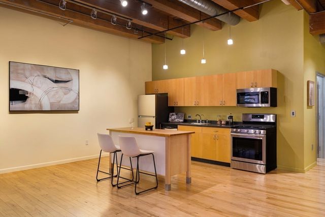 a kitchen with a sink cabinets and refrigerator