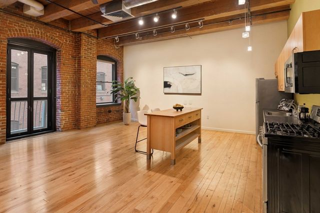 a view of a entryway with furniture and wooden floor