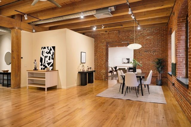 a view of a dining room with furniture and wooden floor