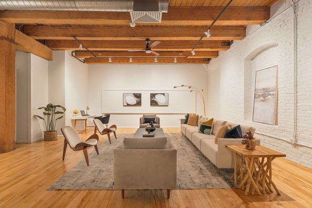 a living room with lots of furniture and wooden floor