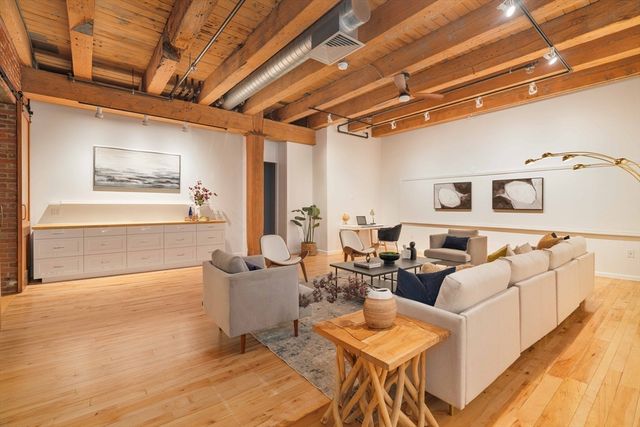 a living room with furniture and white walls
