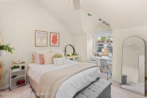 a bedroom with bed and a potted plant