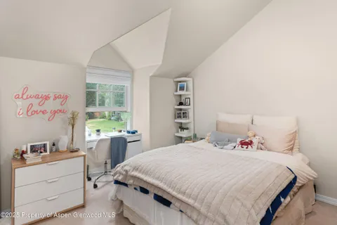 a bedroom with a bed and a desk