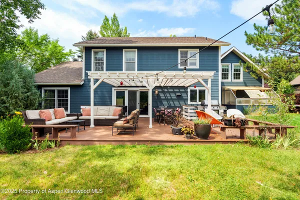 a view of a house with a patio and a yard