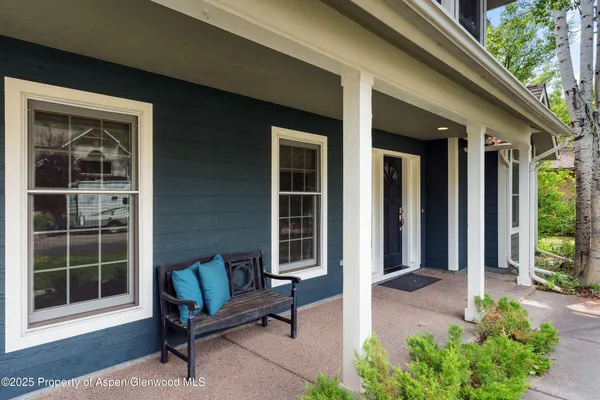 a view of a house with a couches and potted plants