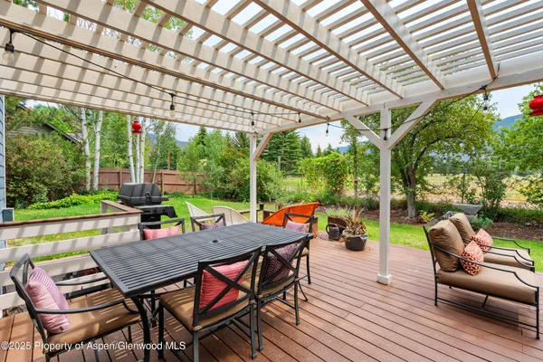 a outdoor view with a sitting space and large trees
