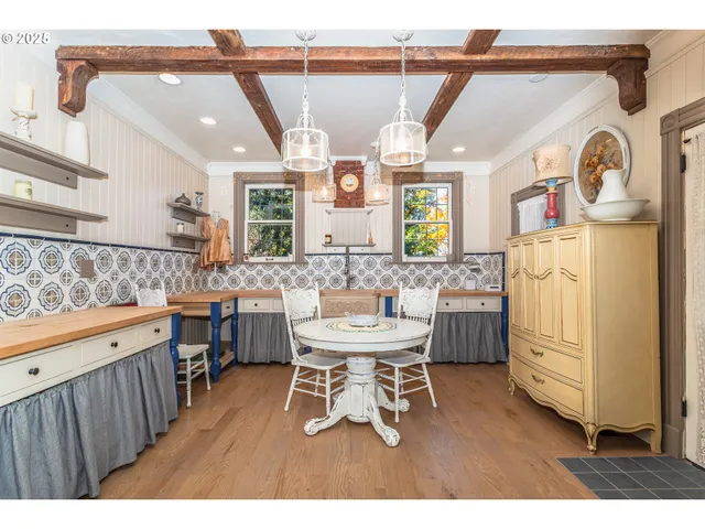 a dining room with a sink a window and chairs