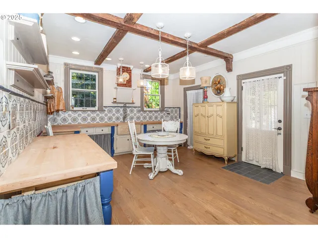 a kitchen with a sink cabinets and wooden floor