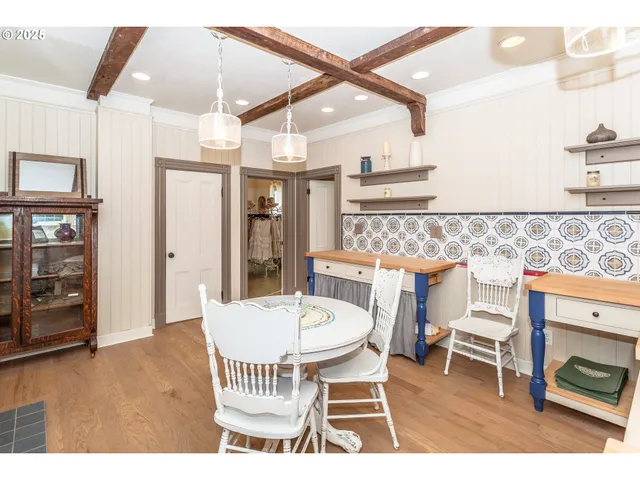 a dining room with furniture and wooden floor