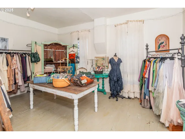 a room with lots of furniture and clothes