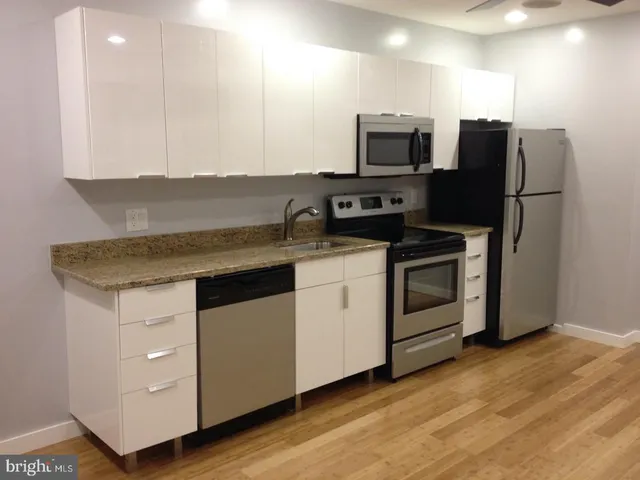 a kitchen with appliances a sink and a microwave