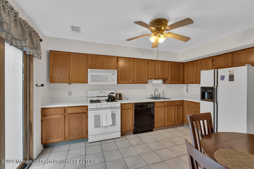 619 Sandra Place Brick, NJ 08724 - Photo 6 of 12 a kitchen with stainless steel appliances granite countertop a stove a sink dishwasher and a refrigerator with cabinets