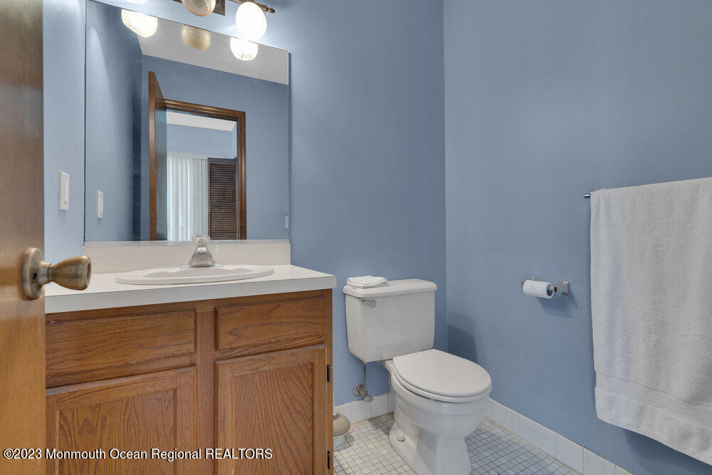 619 Sandra Place Brick, NJ 08724 - Photo 7 of 12 a bathroom with a toilet sink and mirror