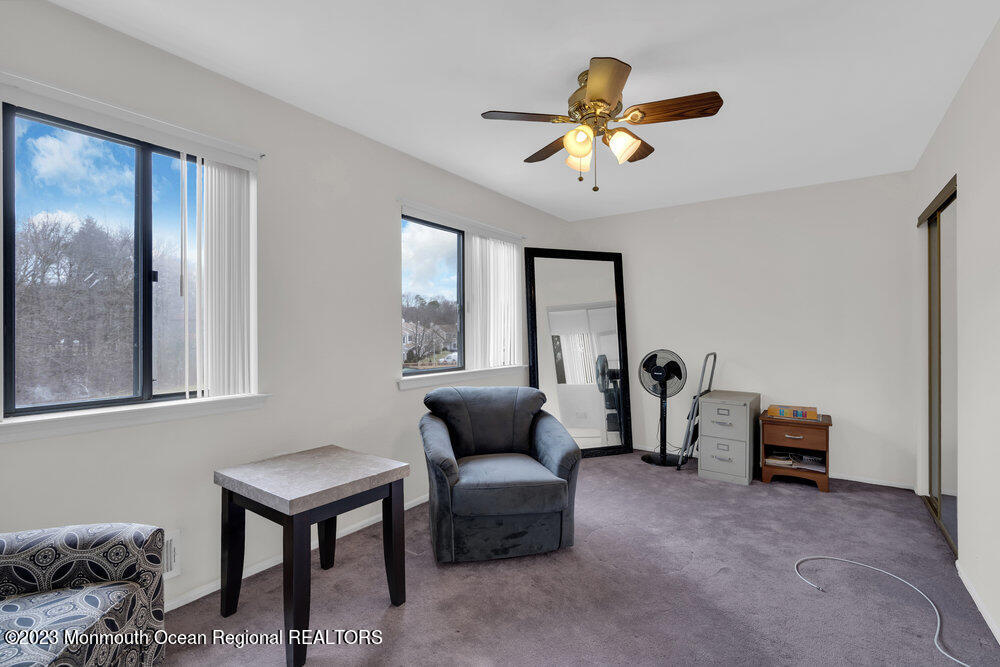 619 Sandra Place Brick, NJ 08724 - Photo 8 of 12 a living room with furniture and a chandelier