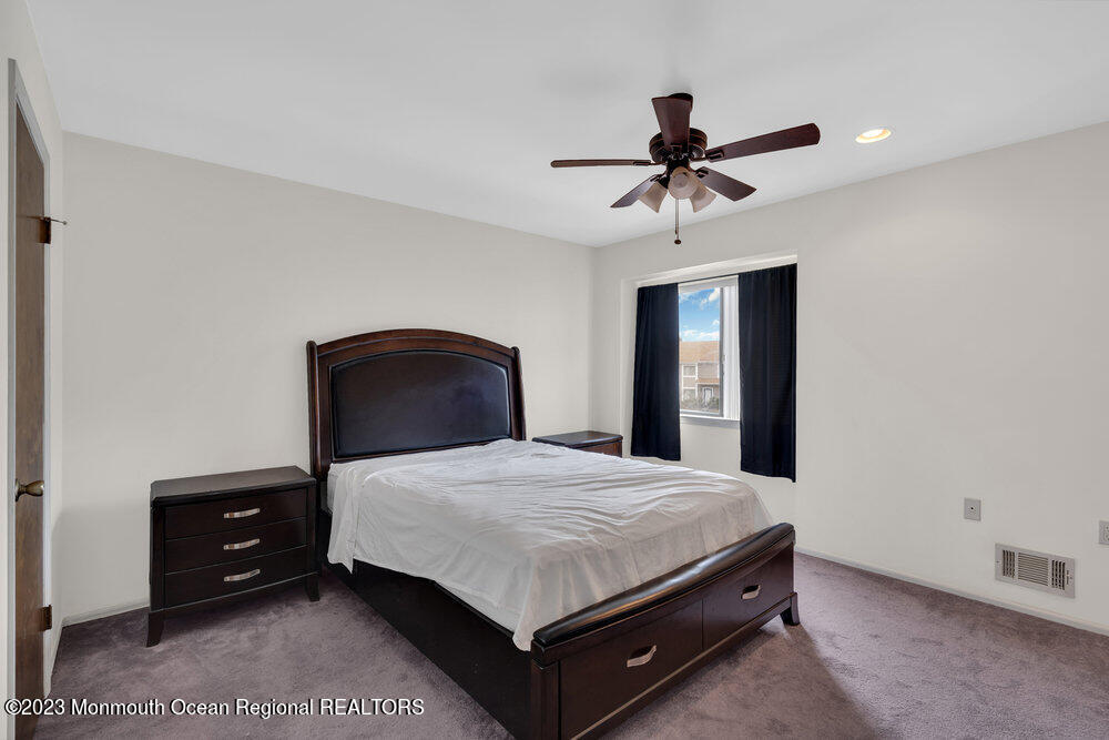 619 Sandra Place Brick, NJ 08724 - Photo 9 of 12 a bedroom with a bed and a chandelier