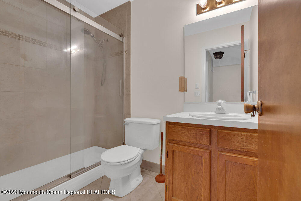 619 Sandra Place Brick, NJ 08724 - Photo 10 of 12 a bathroom with a sink a toilet and shower