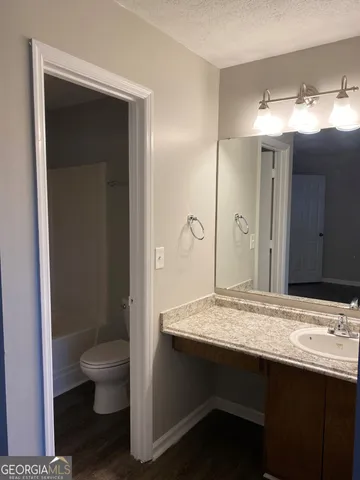 a bathroom with a sink double vanity and a toilet