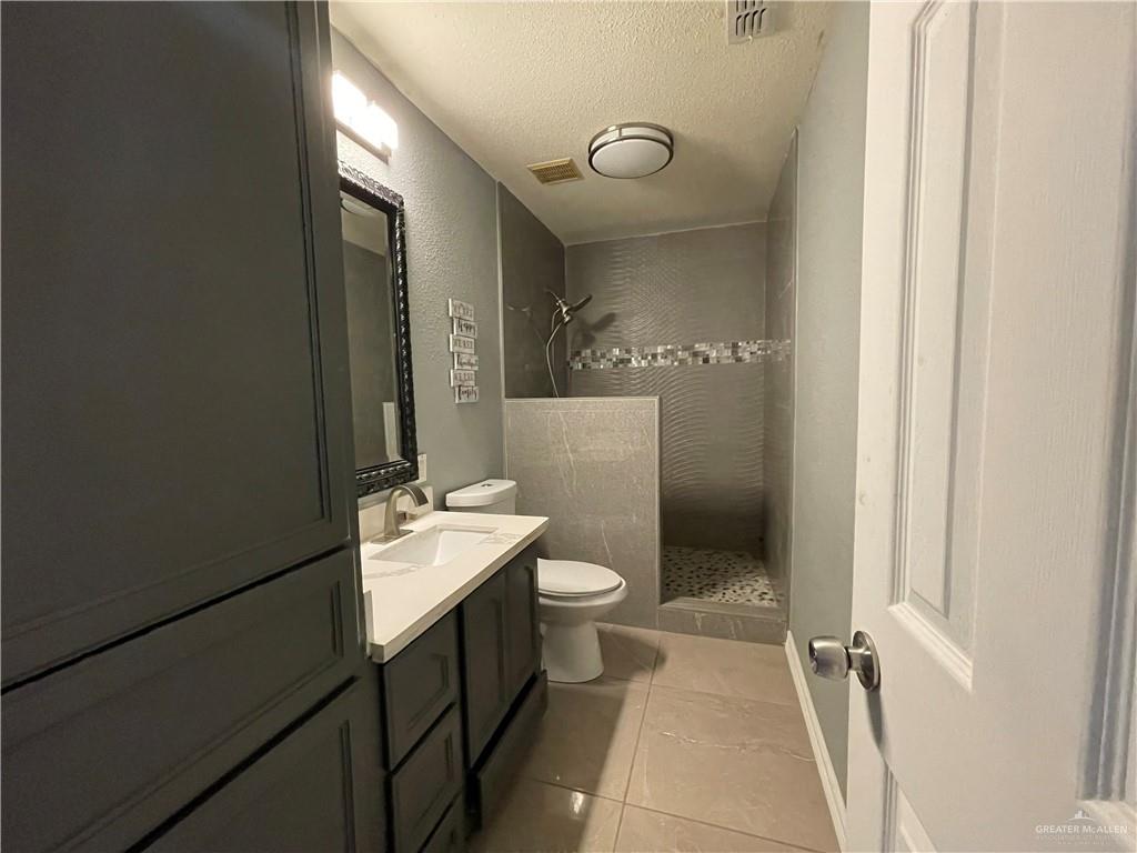 8006 Senecio Street Mission, TX 78574 - Photo 14 of 31 a bathroom with a sink and a mirror